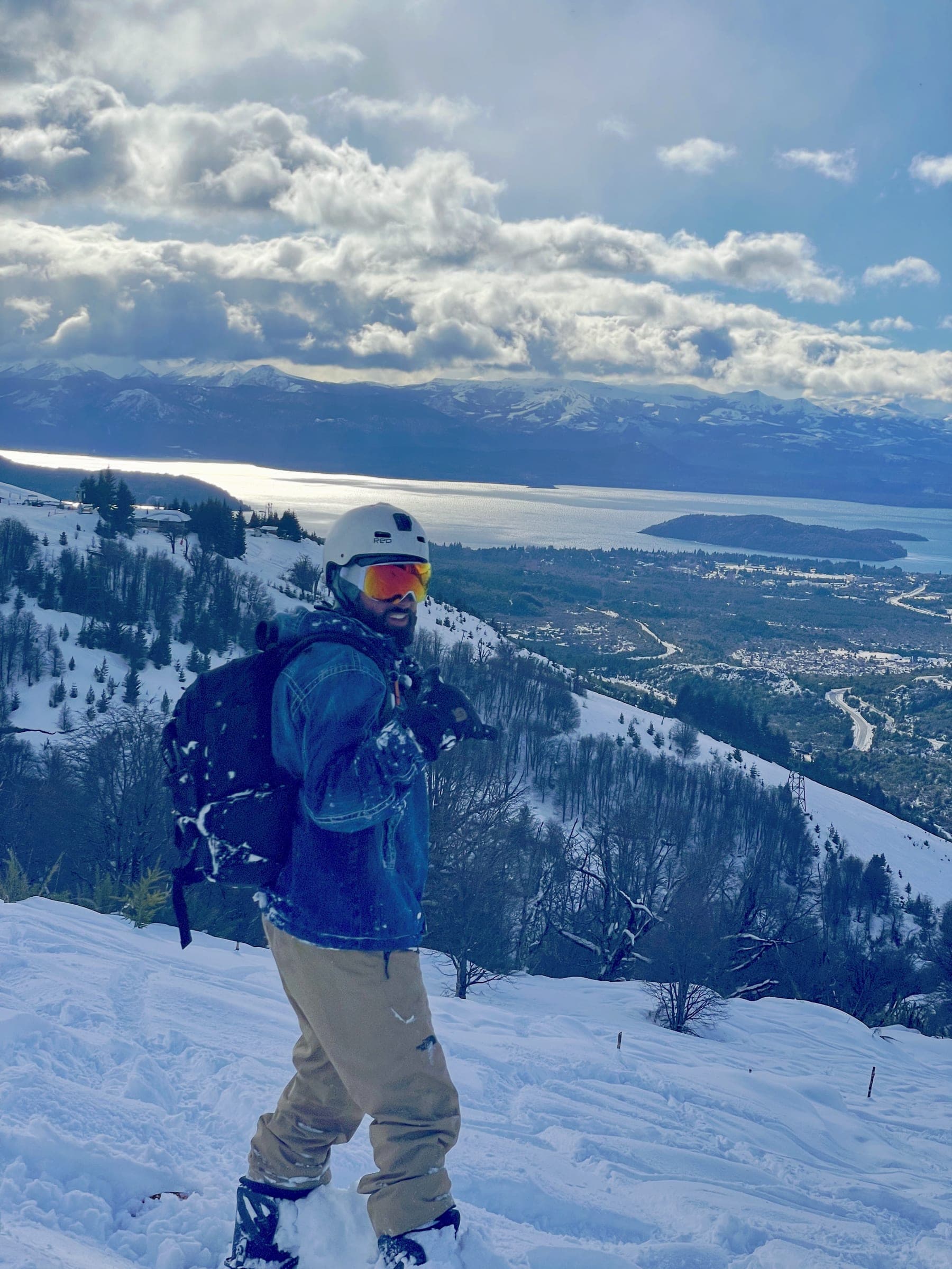 A snowboarder at Cerro Catedral above Lake Nahuel Huapi
