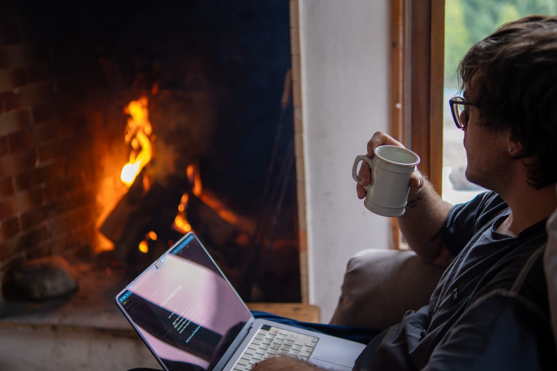 A builder working by the fire after a ski day