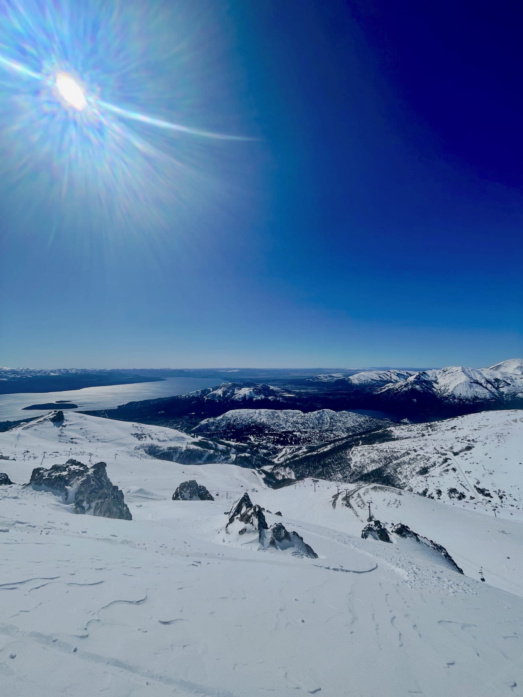 Big snowy terrain and long views over the lake from the top of Cerro Catedral