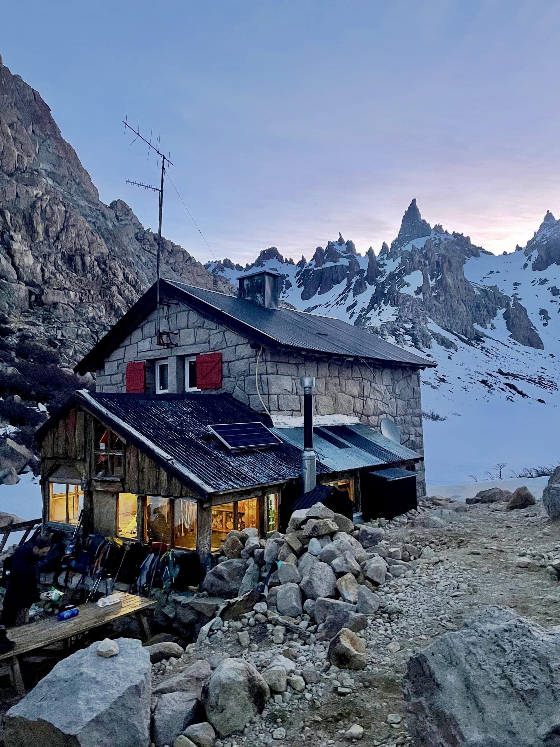 Refugio Frey mountain hut glowing at dusk beneath the Patagonia granite spires